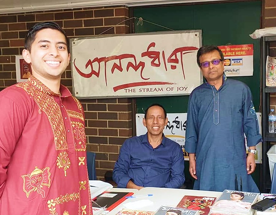 An Anandodhara book stall with members and Bengali magazines on display