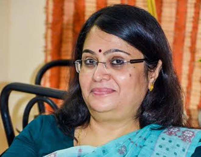 Writer Anita Agnihotri, in a teal sari with glasses, at a literary event